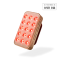 Rectangular LED device with red lights on a white background, featuring 'Vanity Fair' branding.