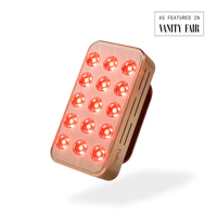 Rectangular LED device with red lights on a white background, featuring 'Vanity Fair' branding.