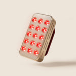 Halio RegenBoost handheld red light therapy panel with 15 glowing red LEDs and a metallic rose-gold finish.