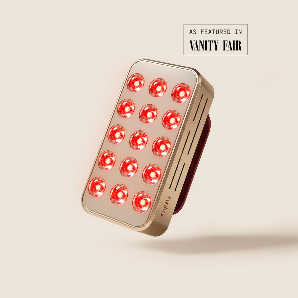 Halio RegenBoost handheld red light therapy panel with glowing LEDs; “AS FEATURED IN VANITY FAIR” text visible.