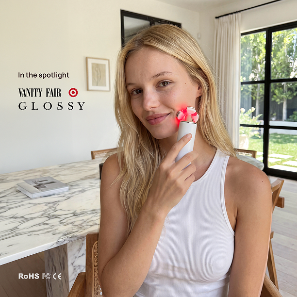 Woman using Halio RevitaWave skincare wand on her cheek; banner reads “In the spotlight VANITY FAIR GLOSSY” and “RoHS FCC CE”